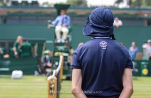 A ball boy stands on Court 17 at the 2018 Wimbledon Championships tennis tournament in London, Great Britain, on Wednesday, July 4, 2018.