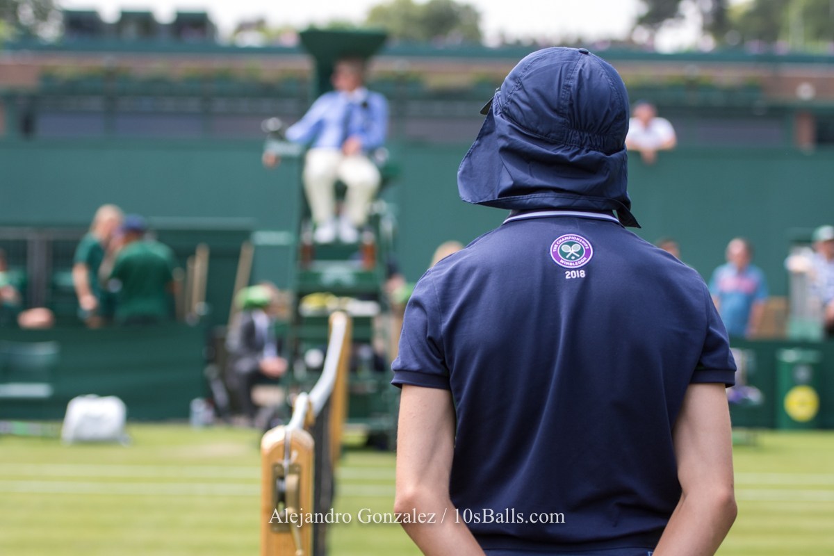 A ball boy stands on Court 17 at the 2018 Wimbledon Championships tennis tournament in London, Great Britain, on Wednesday, July 4, 2018.